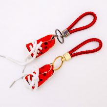 Medal in the form of red shoes for bags